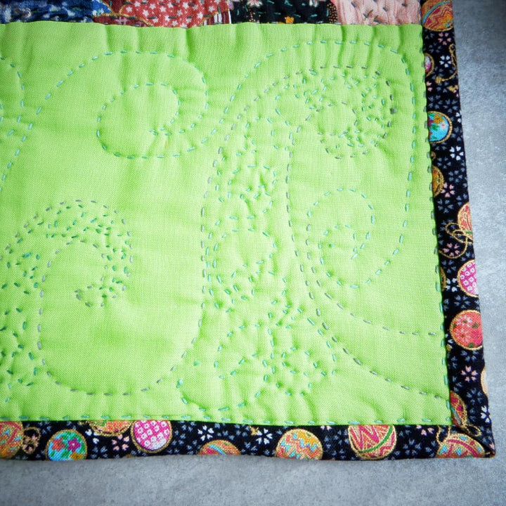 close up of hand stitching on mug rug