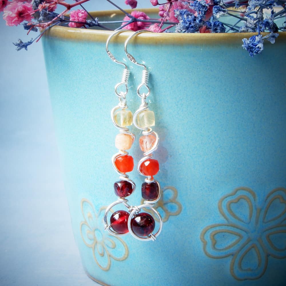 twisted silver dangle earrings with gemstones on turquoise cup