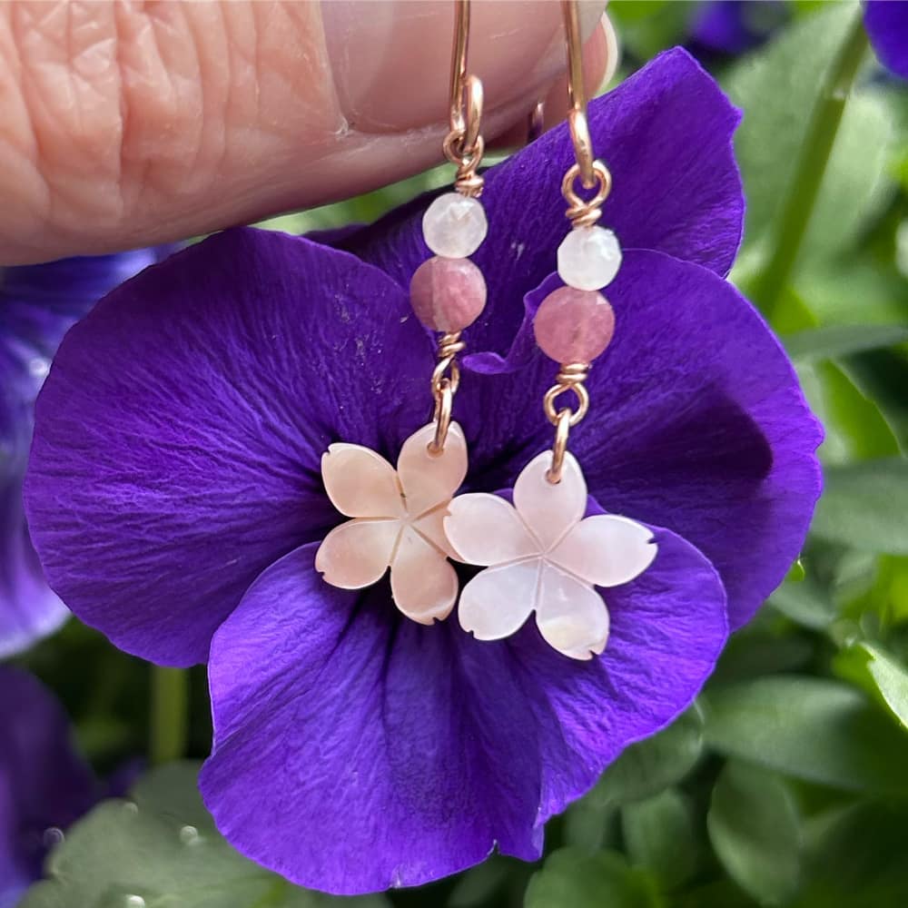 cherry blossom earrings on violet flower background