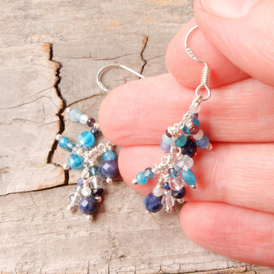 blue gemstone silver chandelier dangle earrings in hand