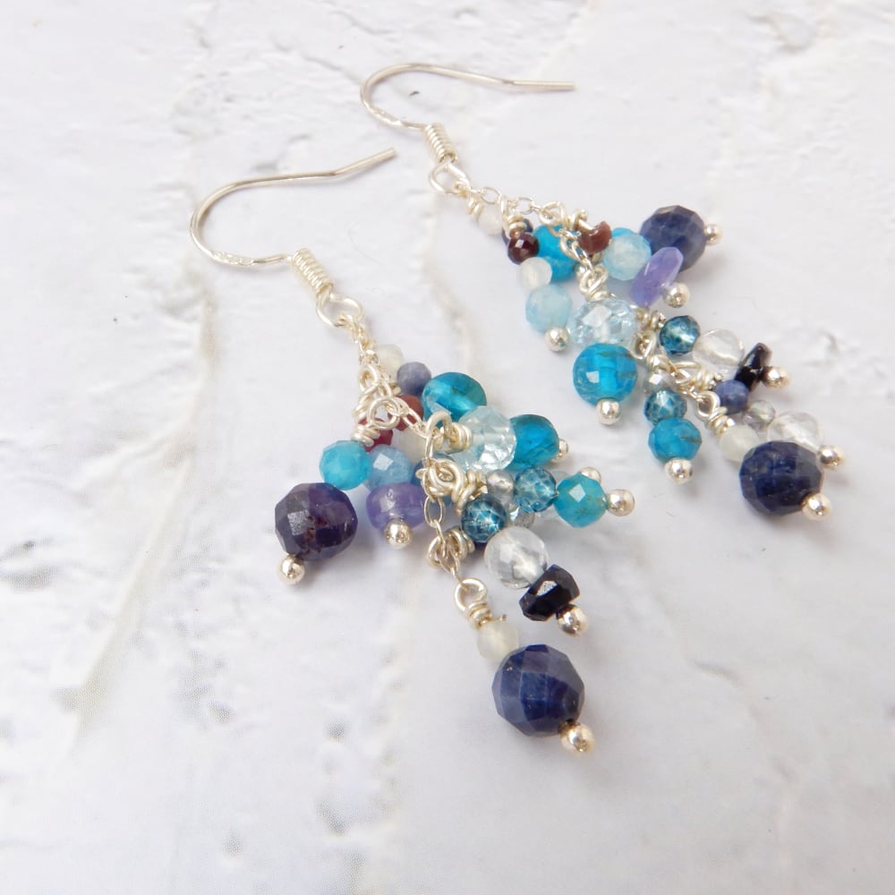 blue gemstone silver chandelier dangle earrings on white background