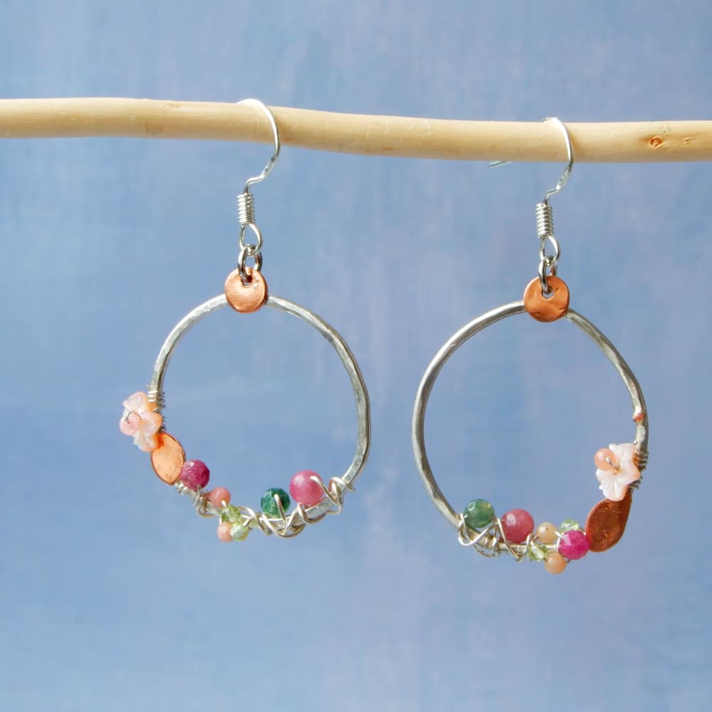 cherry blossom hoop earrings on blue background
