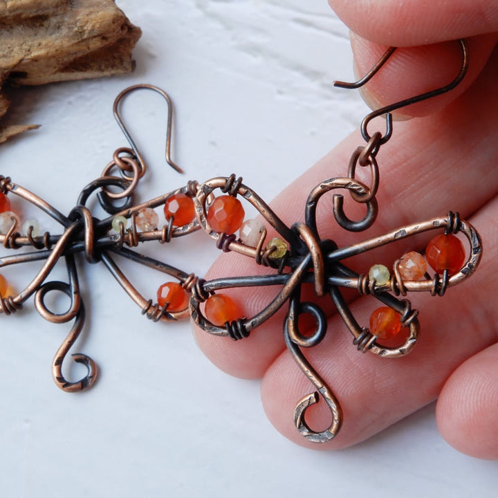 hammered copper dragonfly earrings in hand