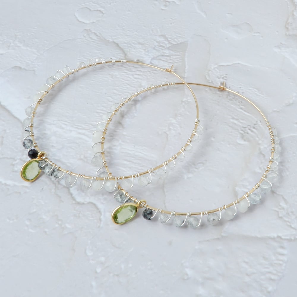 gold filled large gemstone hoops with peridot on white background