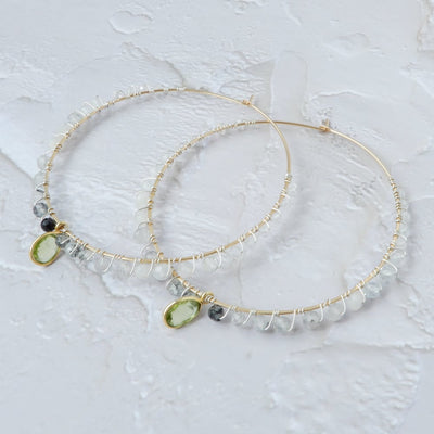 gold filled large gemstone hoops with peridot on white background