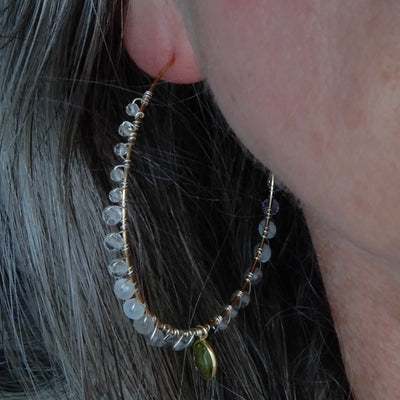 gold filled large gemstone hoops with peridot on model with gray hair